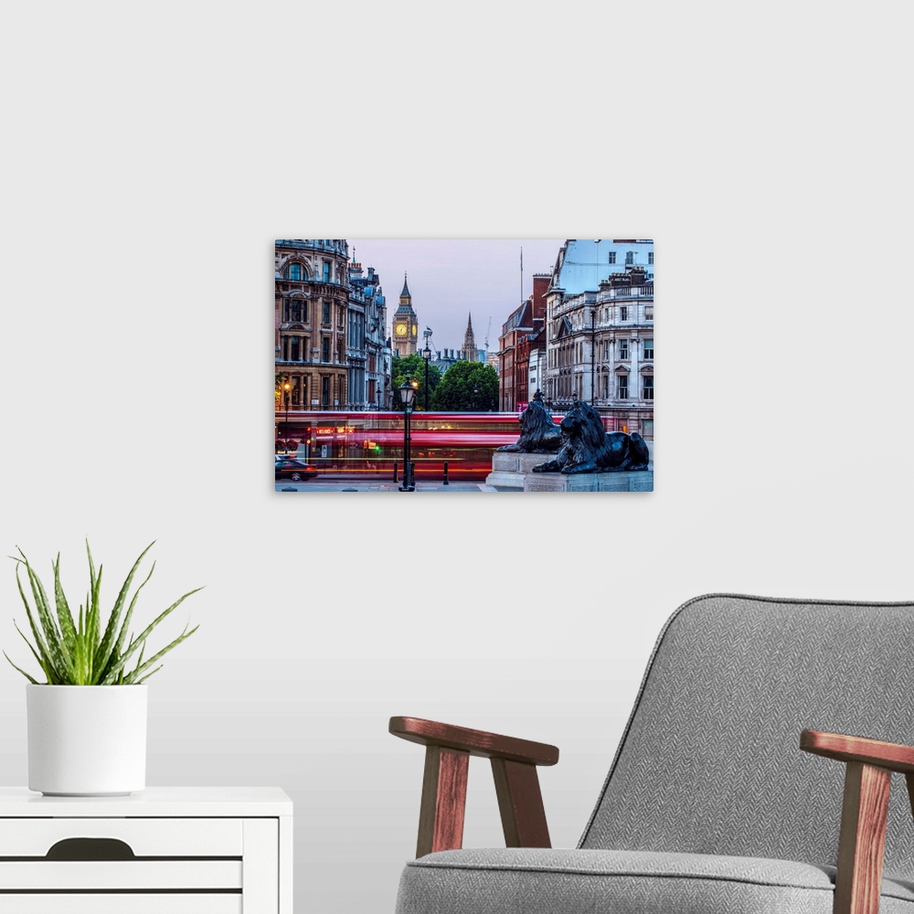 A modern room featuring View of Big Ben from Trafalgar Square with a slow shutter speed of a double decker bus in London,...