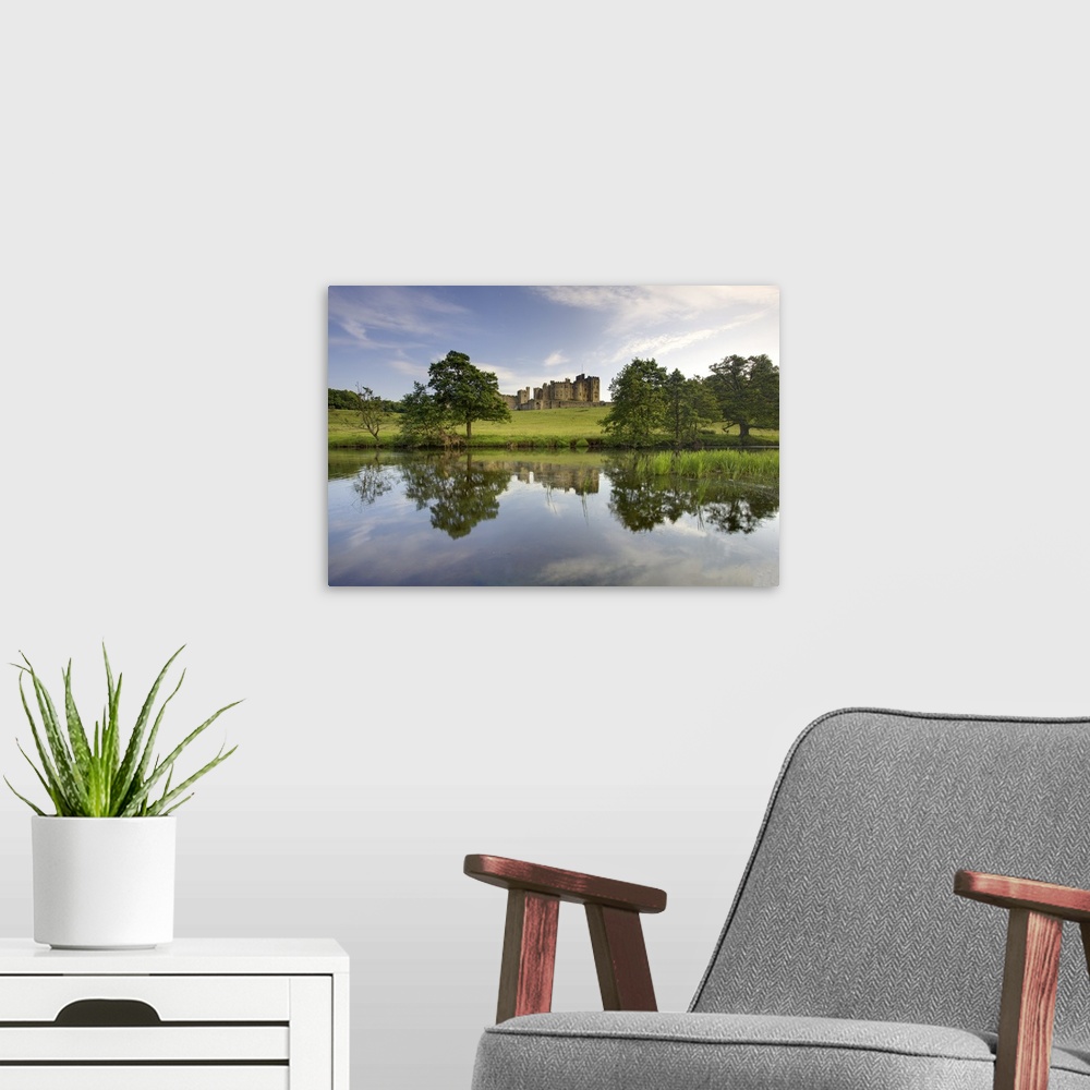 A modern room featuring Alnwick Castle reflecting in River Aln, Alnwick, Northumberland, England