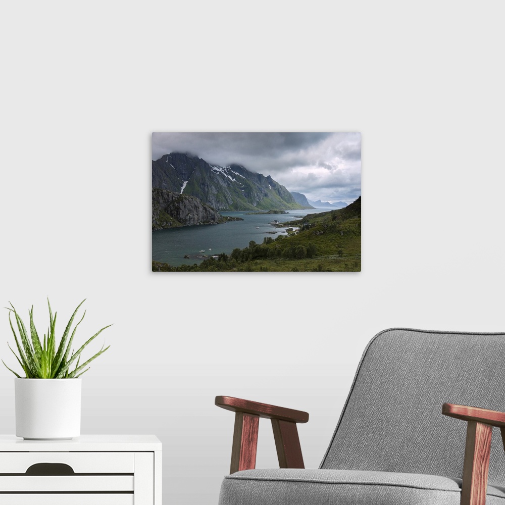 A modern room featuring Blue lights and clouds on the calm sea surrounded by rocky peaks at night, Tangstadpollen, Vestva...