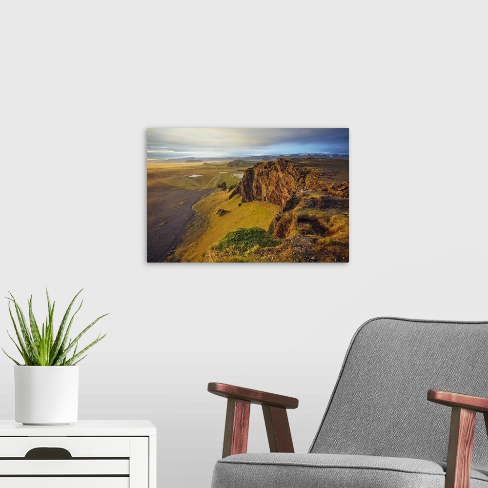 A modern room featuring Cliff and mountain view from Dyrholaey Island, just before sunset, near Vik, south coast of Icela...