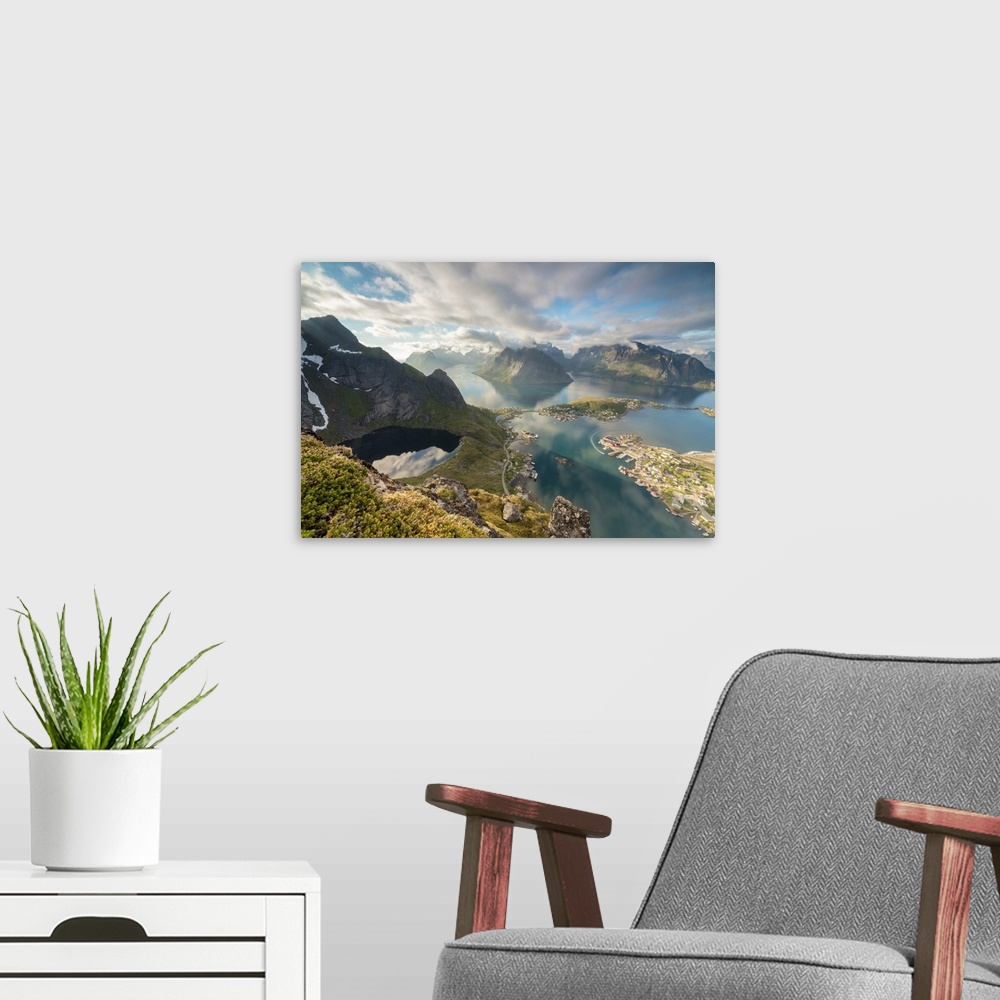 A modern room featuring Clouds reflected in blue lake and sea framed by rocky peaks, Reinebringen, Moskenesoya, Lofoten I...
