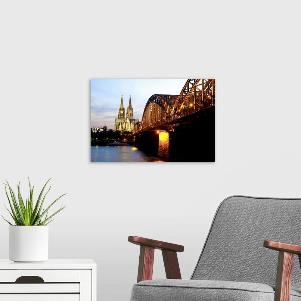 A modern room featuring Cologne cathedral and Hohenzollern bridge at night, Cologne, Germany