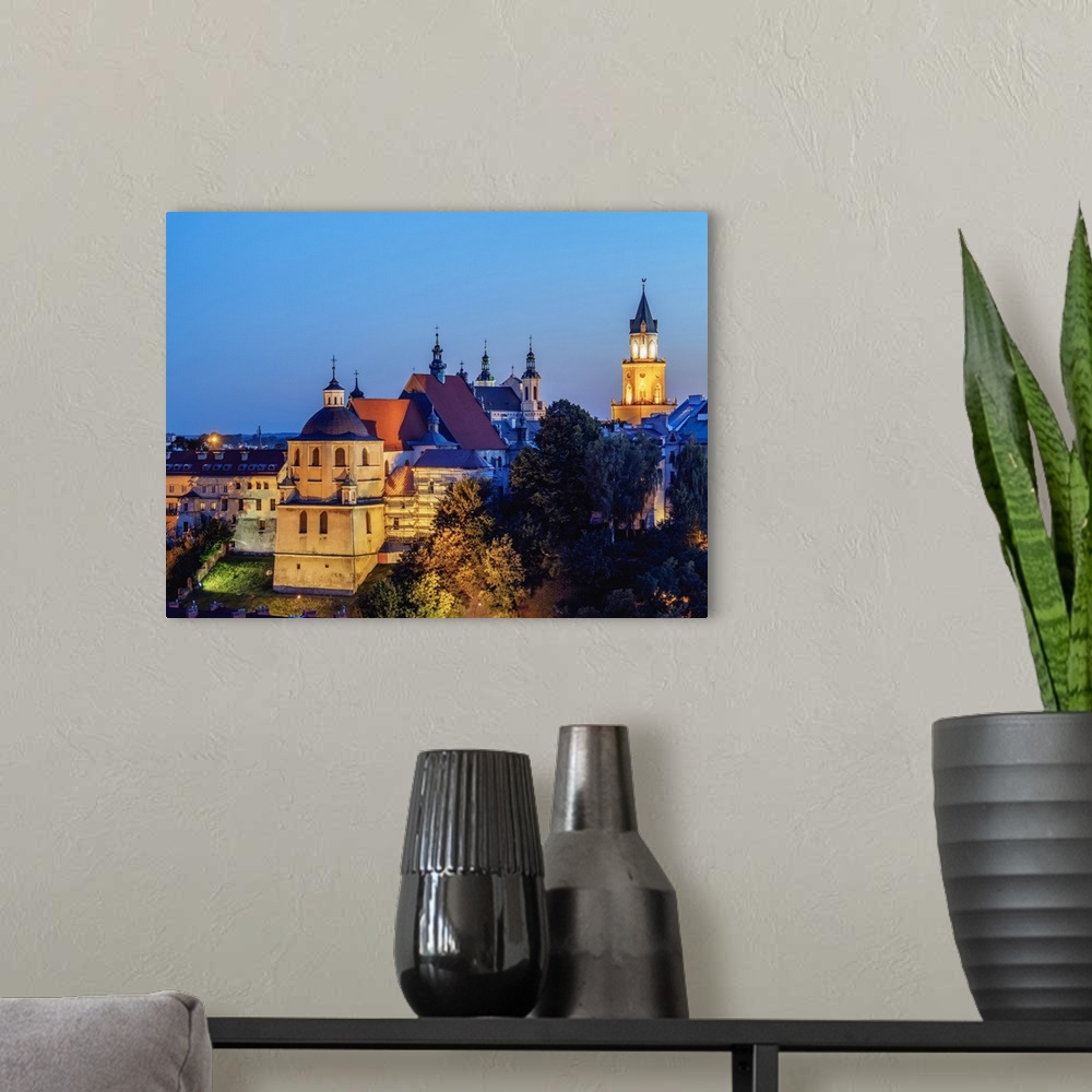 A modern room featuring Dominican Priory and Trinitarian Tower at twilight, Old Town, City of Lublin, Lublin Voivodeship,...