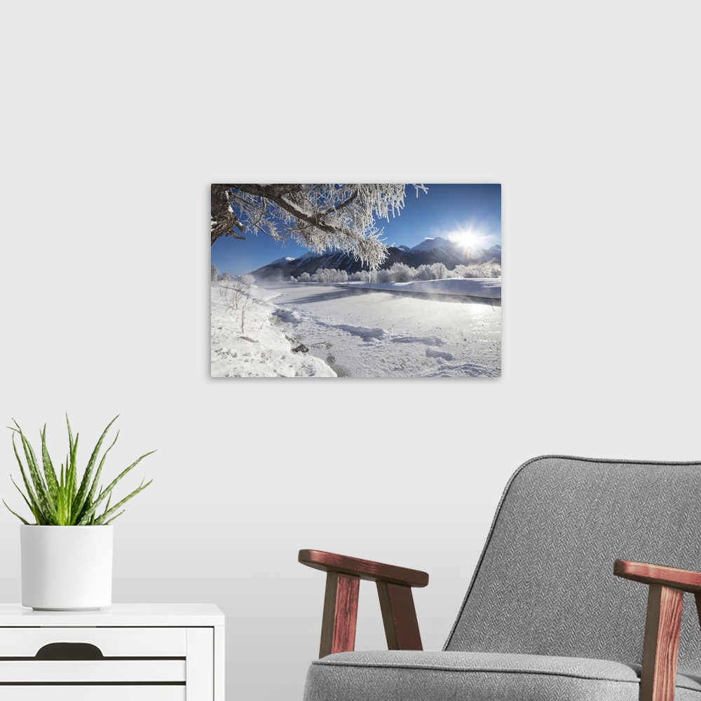 A modern room featuring Frost on trees frame the snowy landscape and frozen river, Inn, Celerina, Maloja, Canton of Graub...
