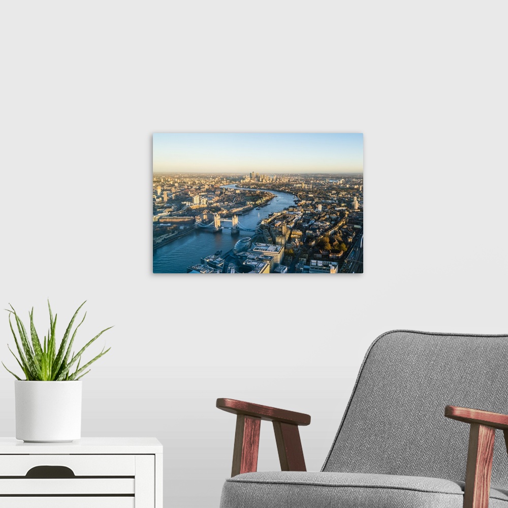 A modern room featuring High view of London skyline along the River Thames from Tower Bridge to Canary Wharf, London, Eng...