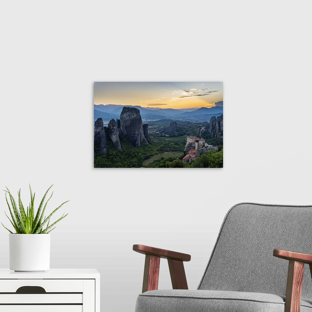 A modern room featuring Holy Monastery of St. Nicholas Anapafsas at sunset, UNESCO World Heritage Site, Meteora Monasteri...