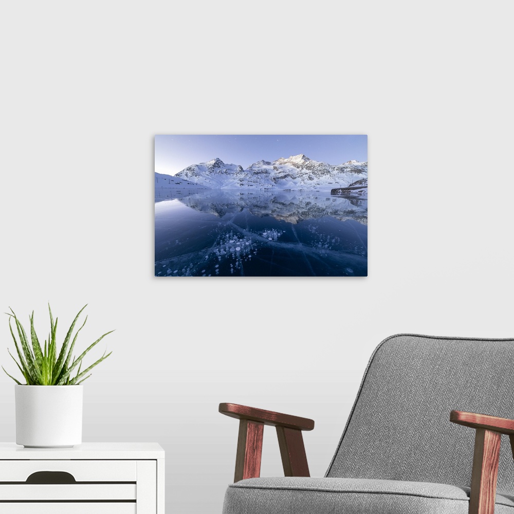 A modern room featuring Ice bubbles frame the snowy peaks reflected in Lago Bianco, Bernina Pass, canton of Graubunden, E...