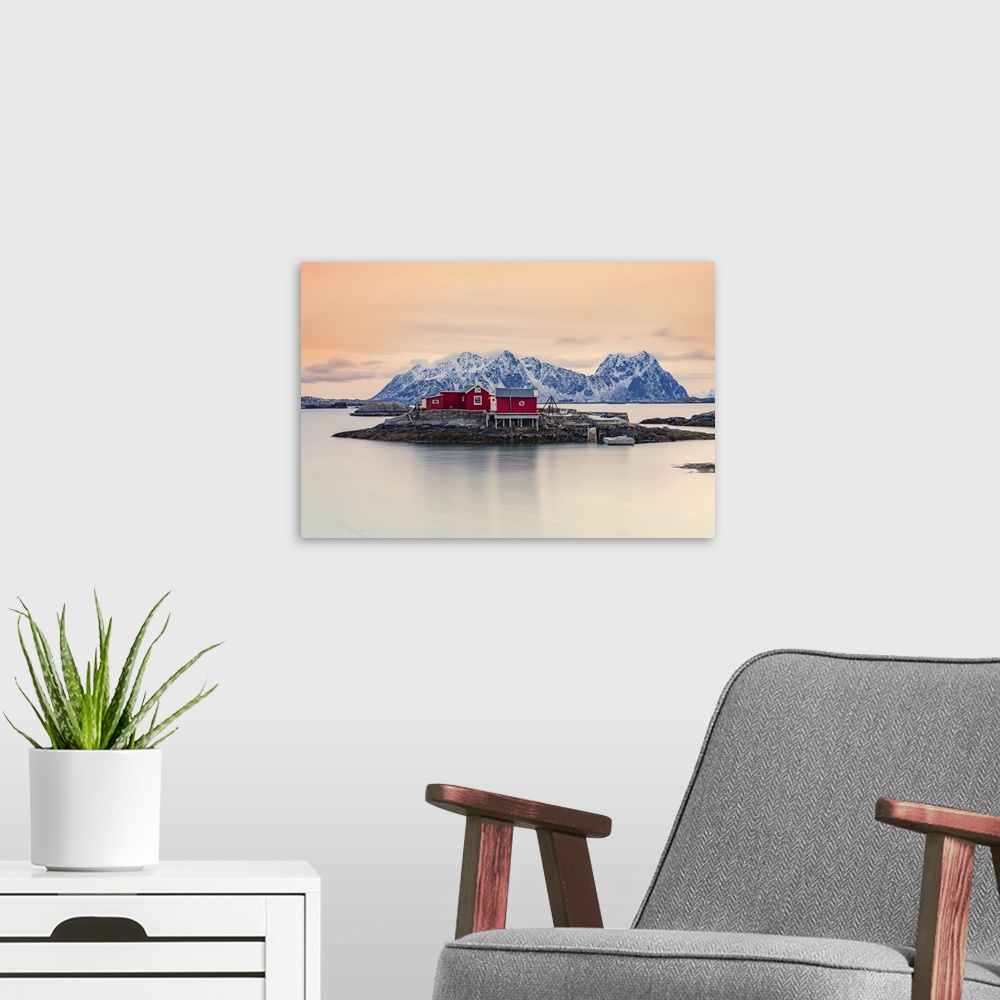 A modern room featuring Isolated red fishermen's cabins on rocks in the cold sea at sunset, Svolvaer, Nordland county, Lo...