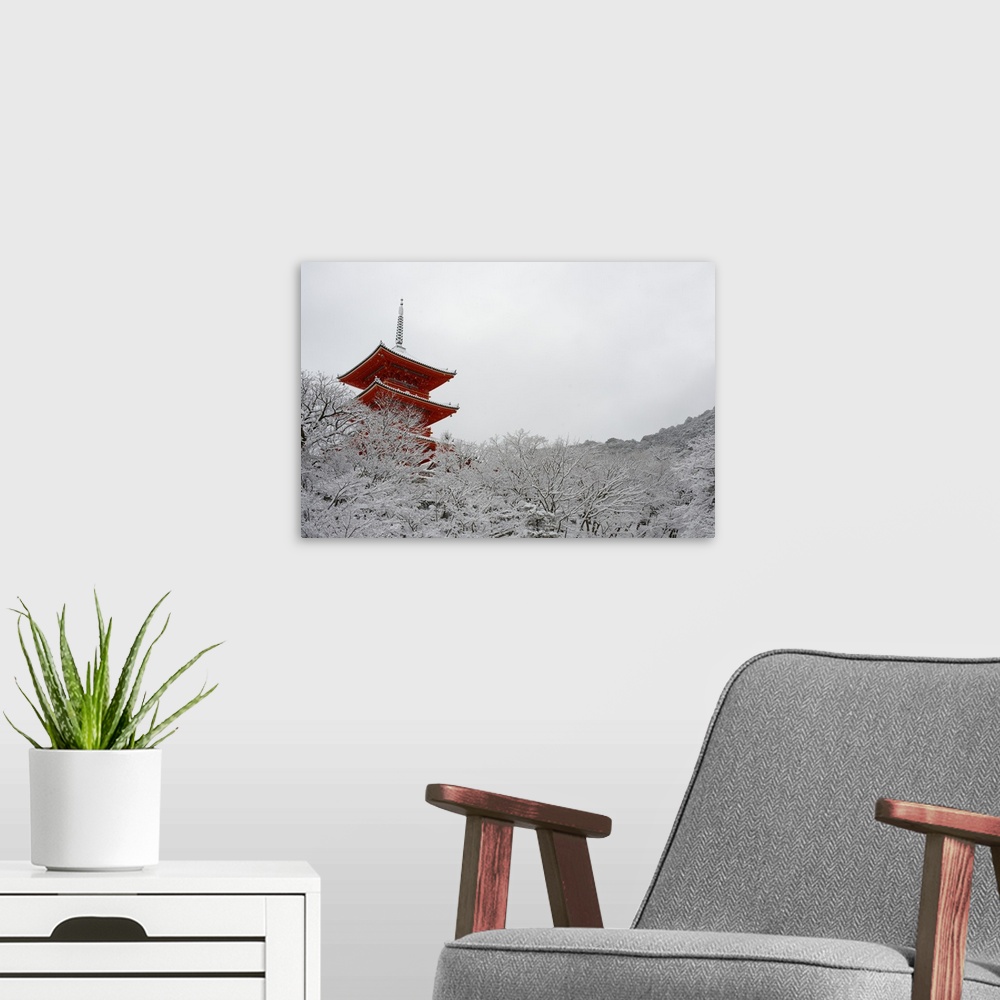 A modern room featuring Kiyomizu-dera Temple's pagoda hiding behind snow-covered trees, Kyoto, Japan