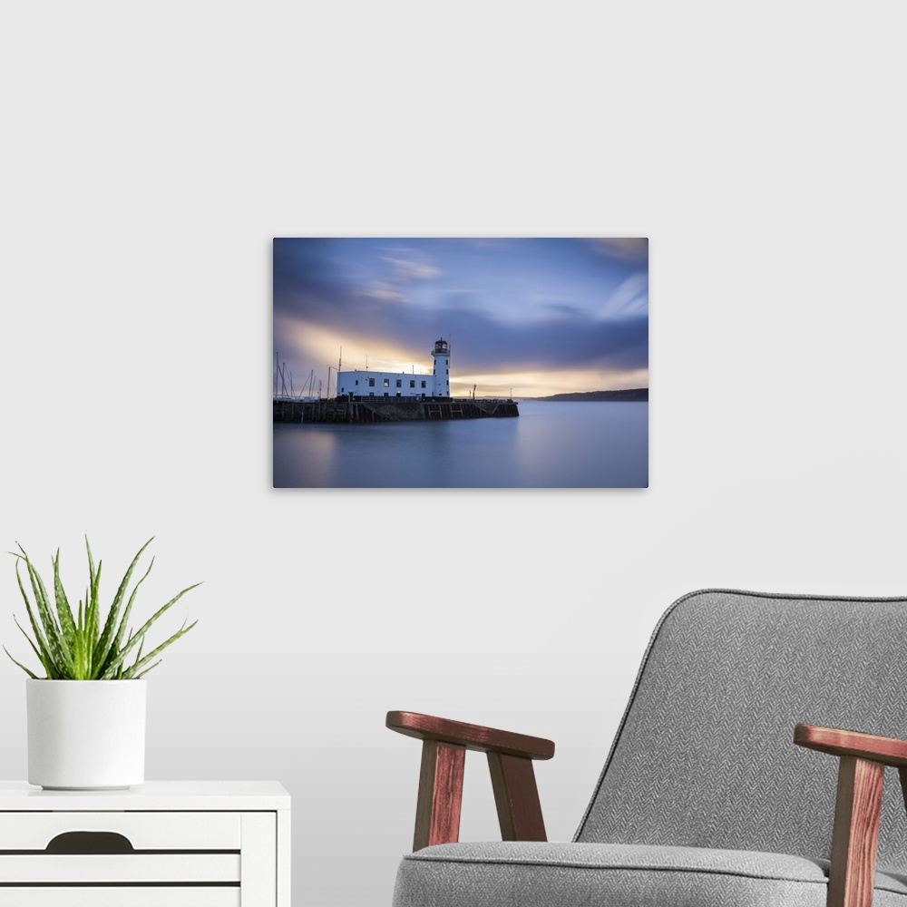 A modern room featuring A long exposure photograph of Scarborough Lighthouse shortly after sunrise, Scarborough, North Yo...
