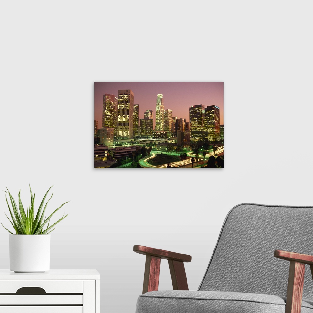 A modern room featuring Los Angeles skyline and freeways, illuminated at night, California, USA