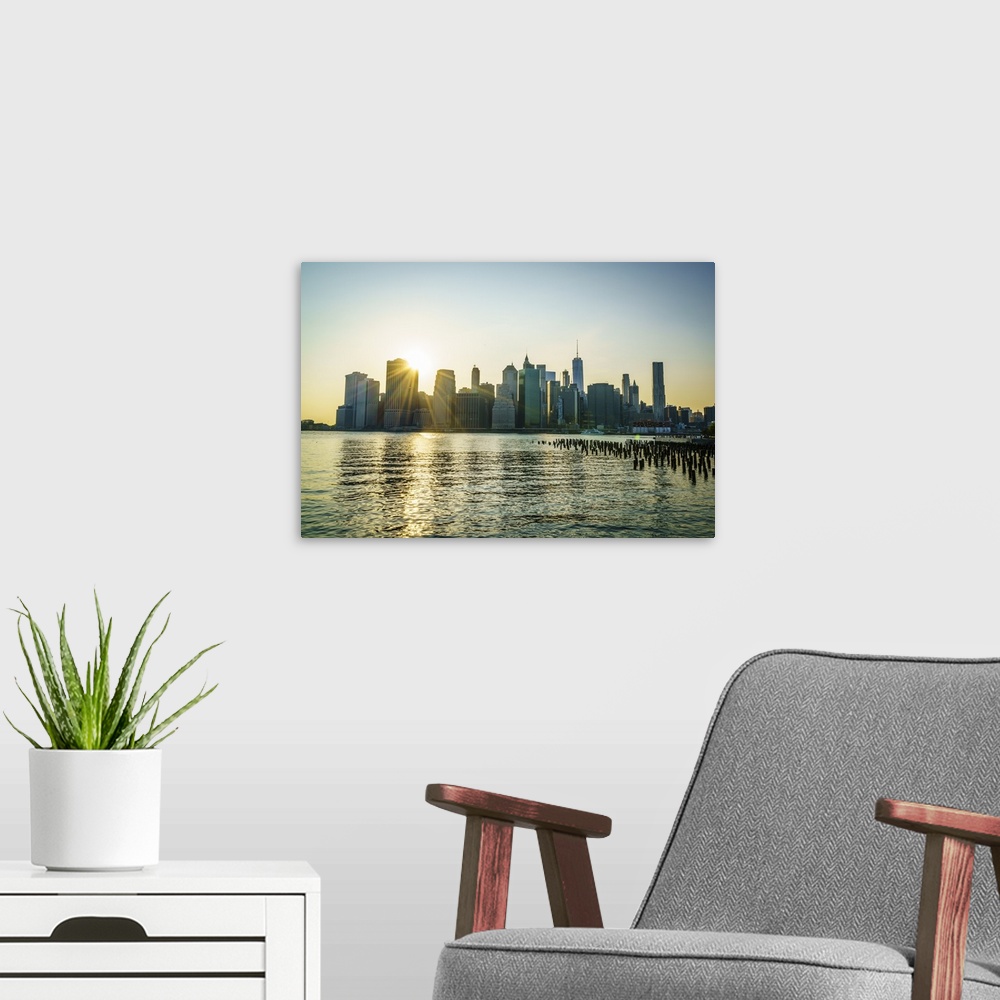 A modern room featuring Manhattan skyline at sunset, New York City, United States of America, North America