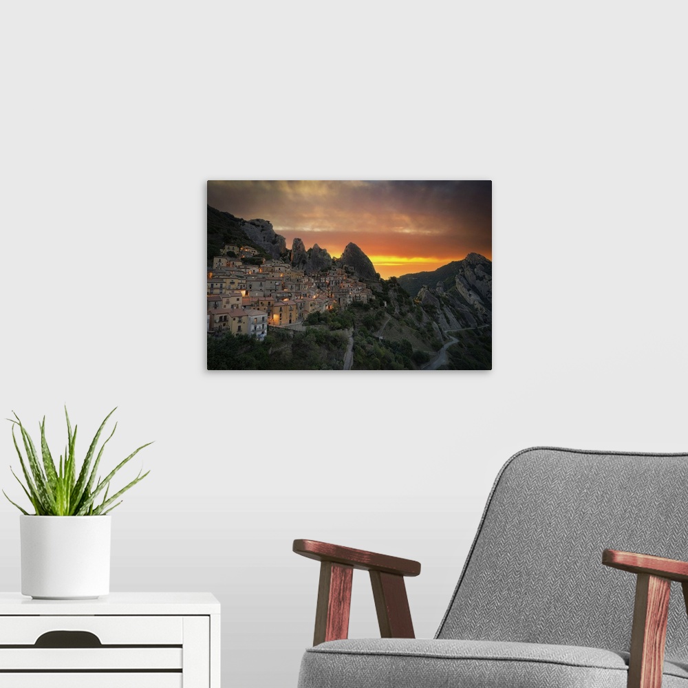 A modern room featuring Burning sky at sunrise over the old houses of Castelmezzano and Dolomiti Lucane mountains, Potenz...