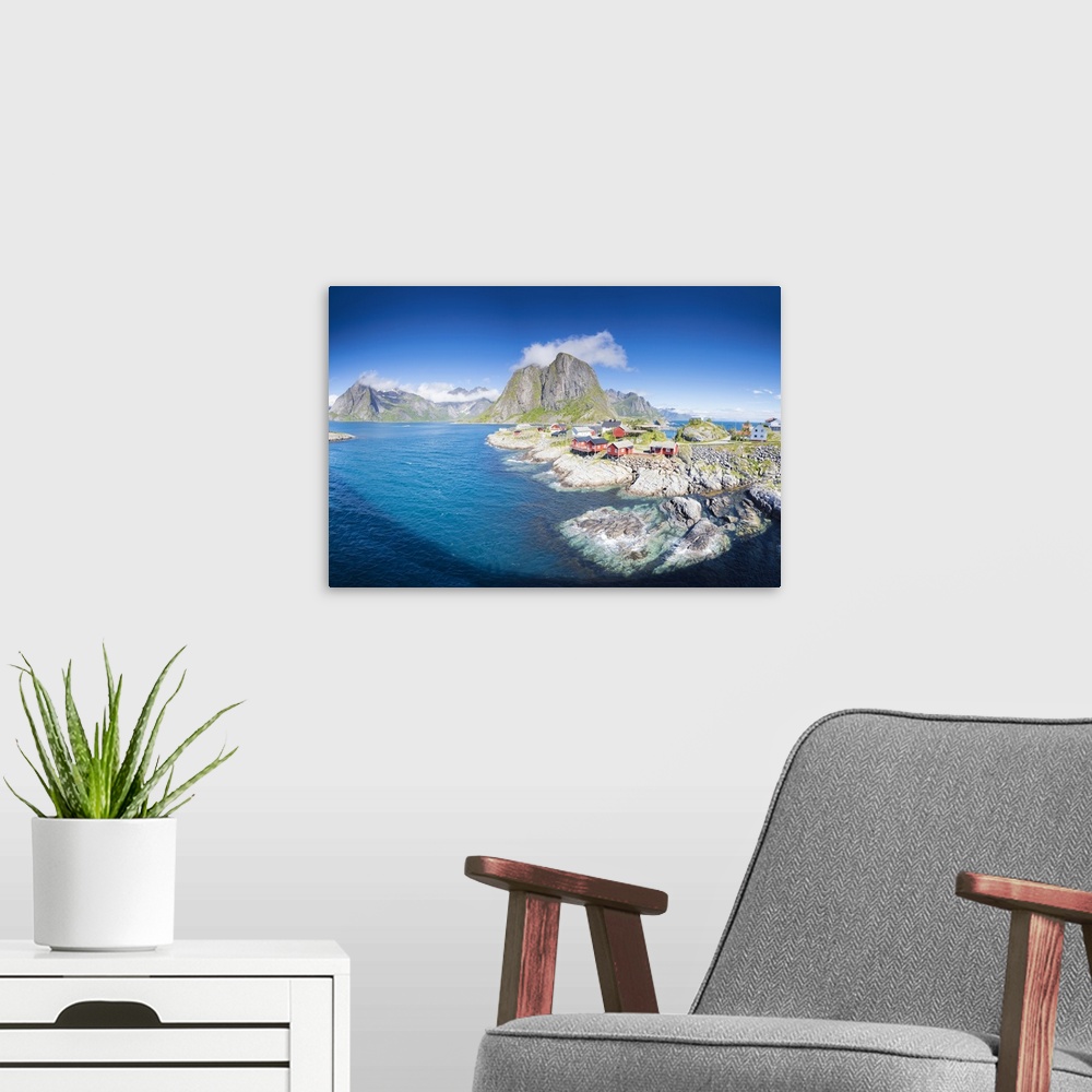 A modern room featuring Panorama of the fishing village framed by blue sea and high peaks, Hamnoy, Moskenesoya, Nordland ...