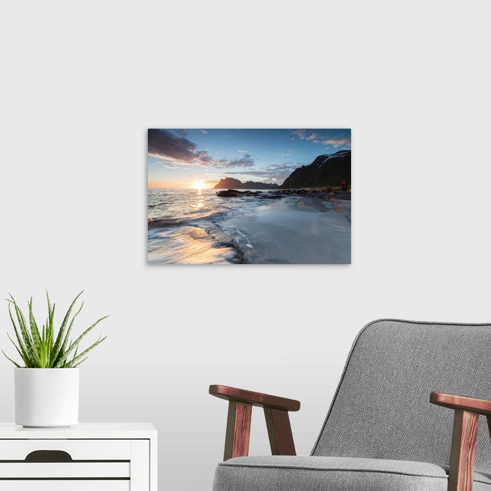 A modern room featuring Pink clouds and midnight sun reflected on the waves of blue sea framed by rocky peaks, Uttakleiv,...