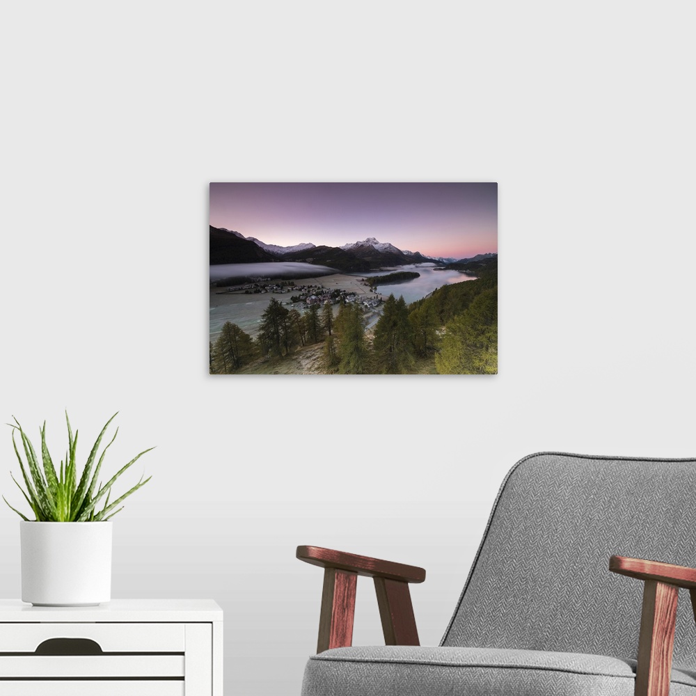 A modern room featuring Pink sky at sunrise and mist on the lake and alpine village of Sils, Canton of Graubunden, Engadi...