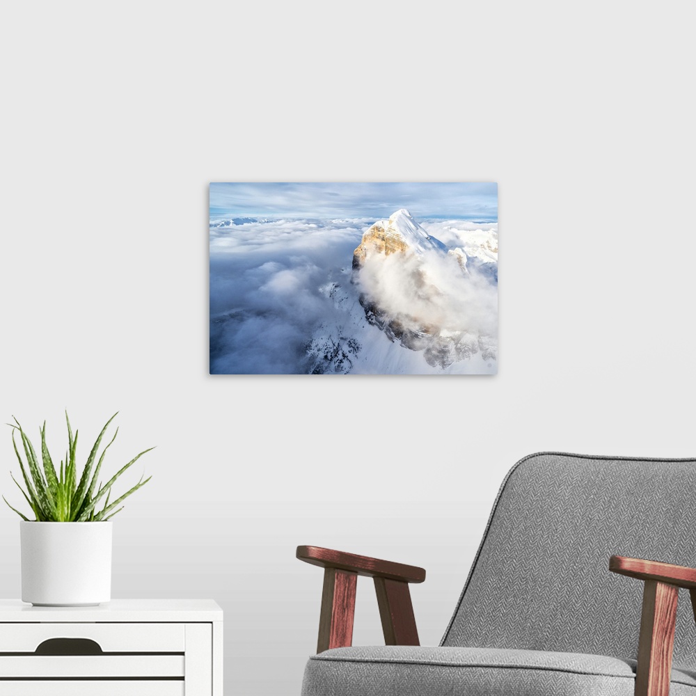 A modern room featuring Snow covered Tofana di Rozes above the clouds, aerial view, Dolomites, Belluno province, Veneto, ...