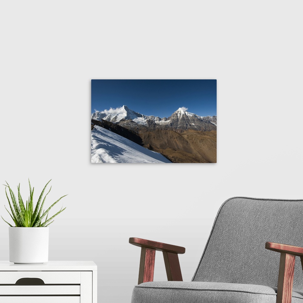 A modern room featuring Snow on the Nyile La, a 4950m pass, and the peak of Jitchu Drake at 6714m in the distance, Bhutan...