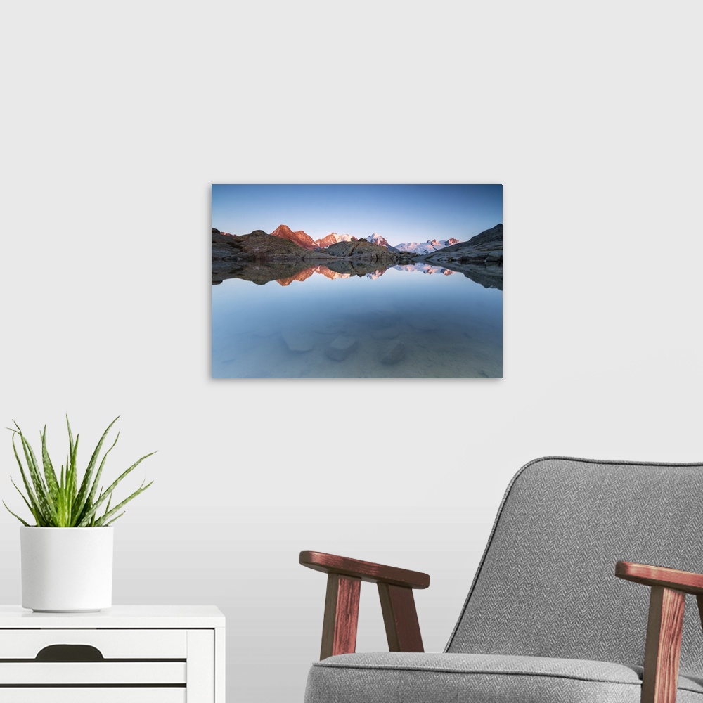 A modern room featuring Snowy peaks reflected in the alpine lake at sunset, Fuorcla, Surlej, St. Moritz, Canton of Graubu...