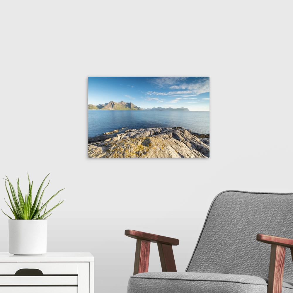 A modern room featuring Sun shines on the blue sea and the rocky peaks at night during summer, Vikten, Nord Trondelag, Lo...