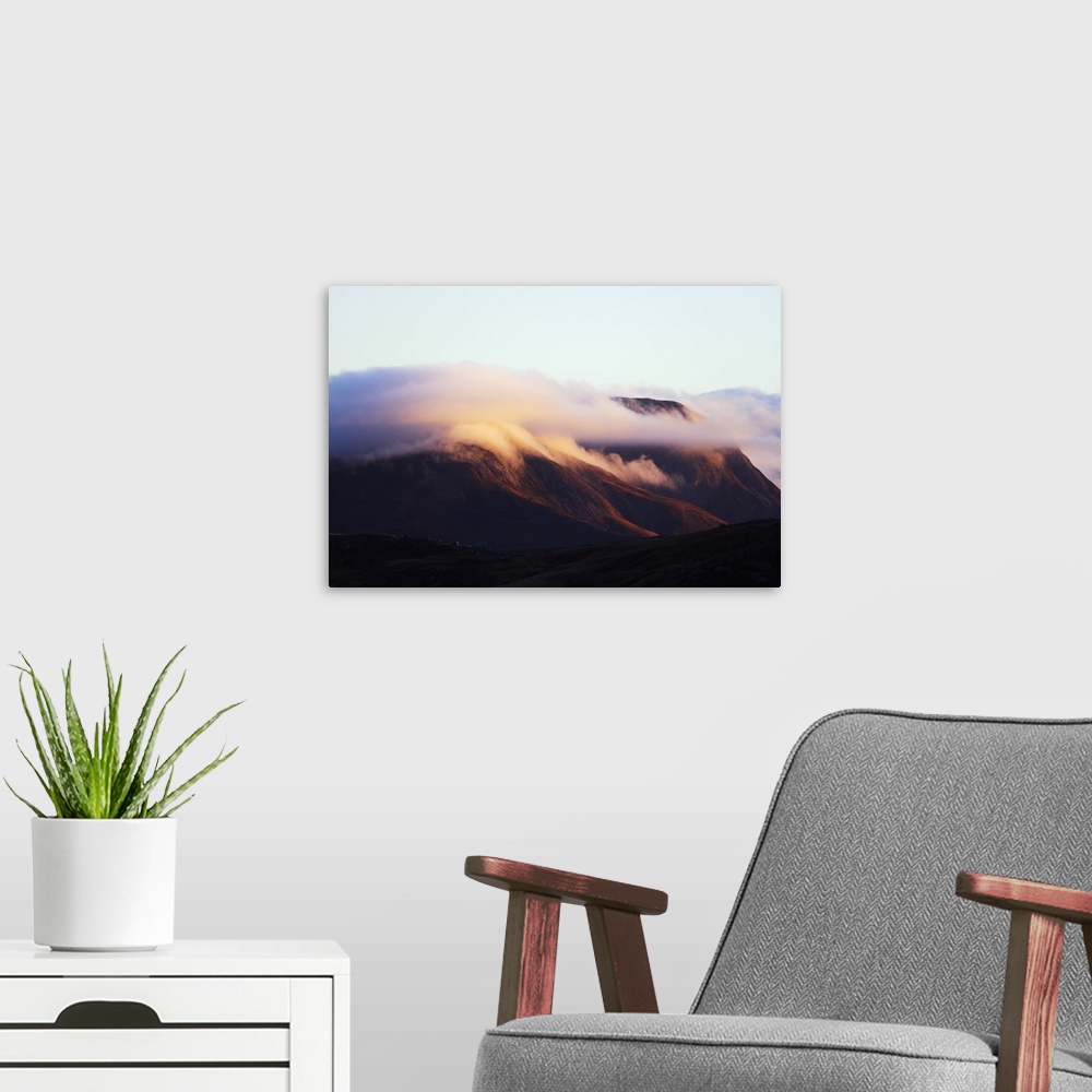 A modern room featuring Sunrise on a cloud topped mountain, Andringitra National Park, Ambalavao, central area, Madagasca...