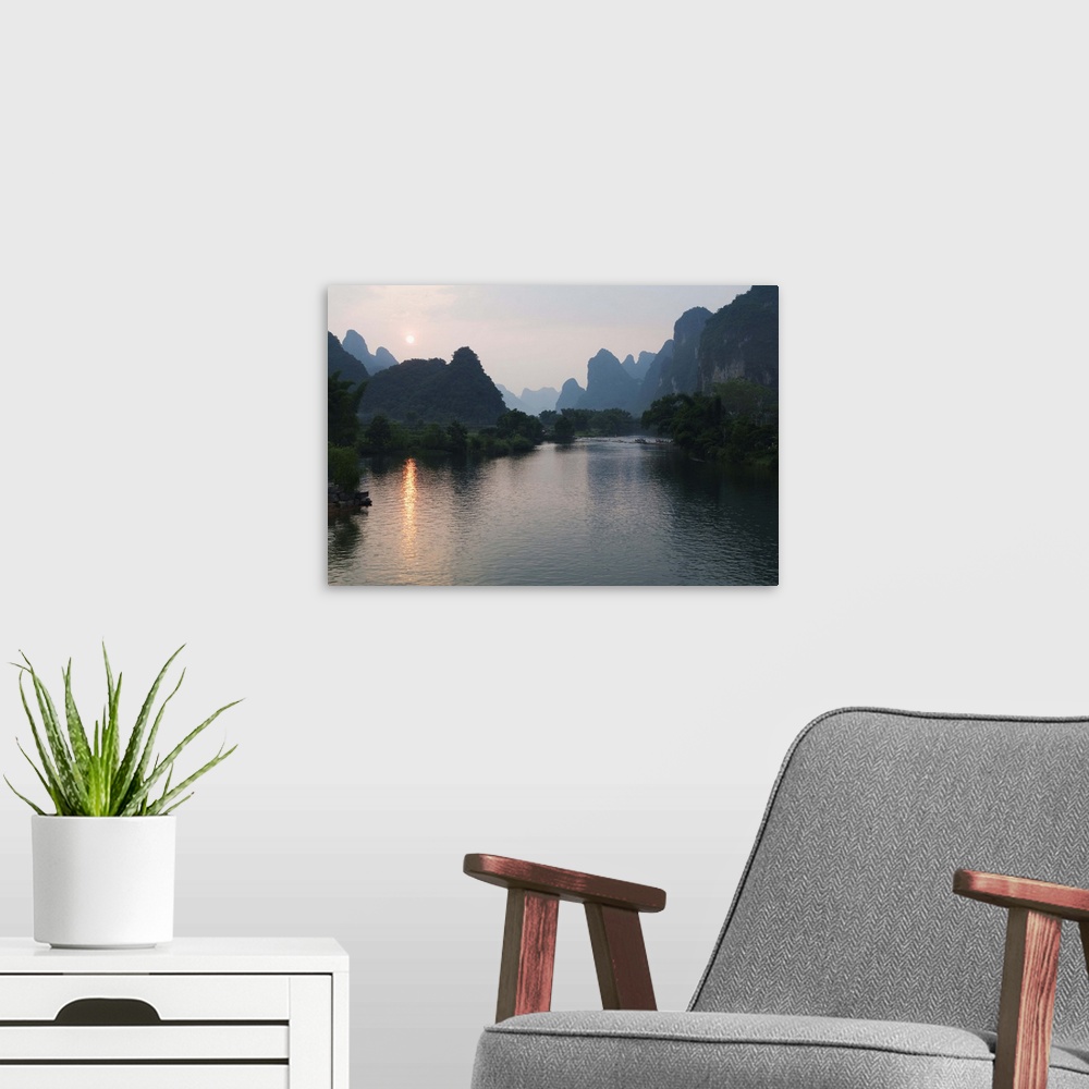 A modern room featuring Sunset over karst limestone scenery on the Li river in Yangshuo, China