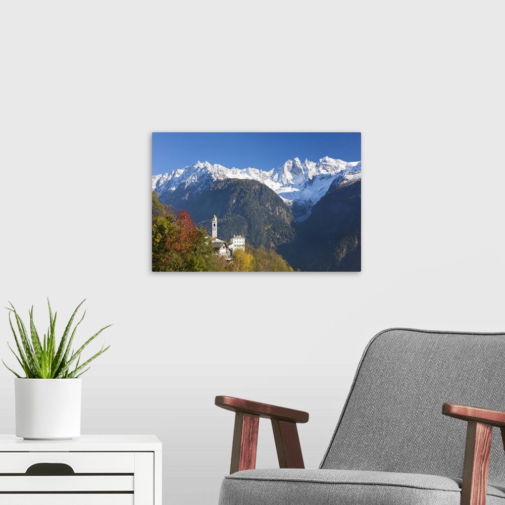 A modern room featuring The colorful trees frame the alpine church and the snowy peaks, Soglio, Bregaglia Valley, Canton ...