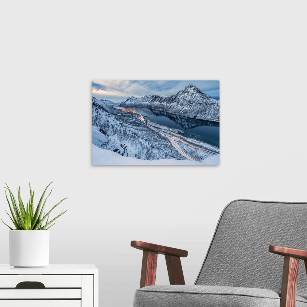 A modern room featuring The snowy peaks above the frozen sea framed by the blue lights of dusk, Gryllefjorden, Senja, Tro...