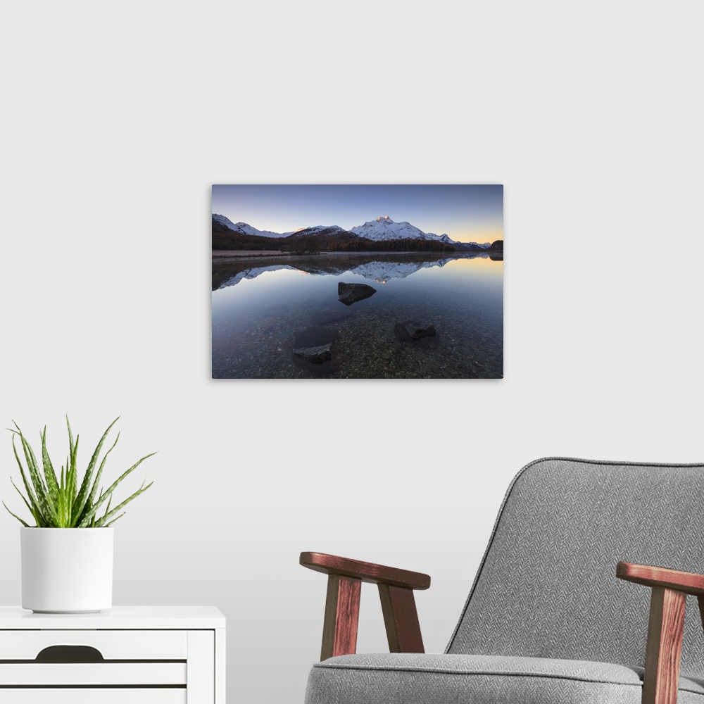A modern room featuring The snowy peaks are reflected in Lake Champfer at sunrise, St. Moritz, Canton of Graubunden, Enga...