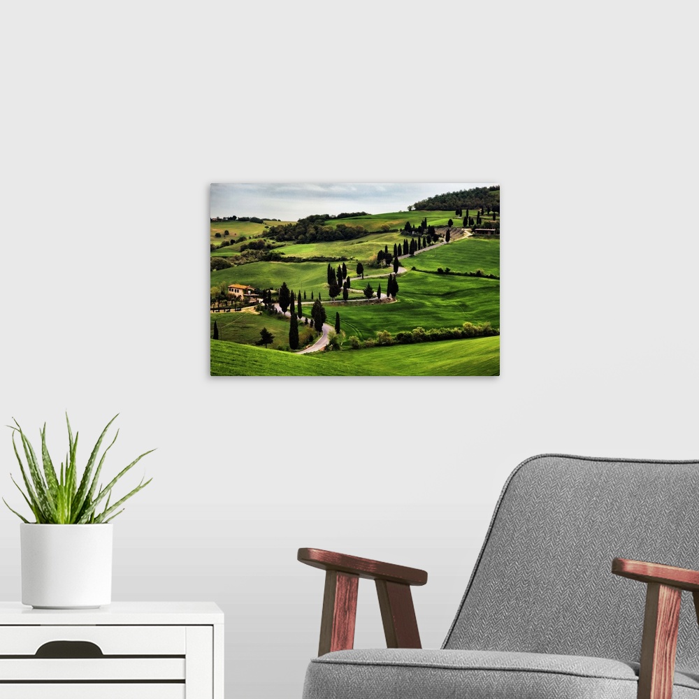 A modern room featuring Big canvas print of a countryside with a winding road running through it.