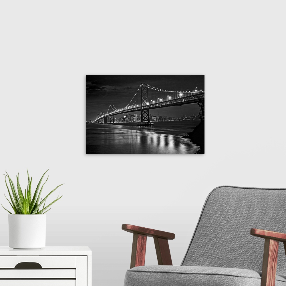 A modern room featuring This landscape is a high contrast, monochromatic photograph that shows a bridge in the fore groun...