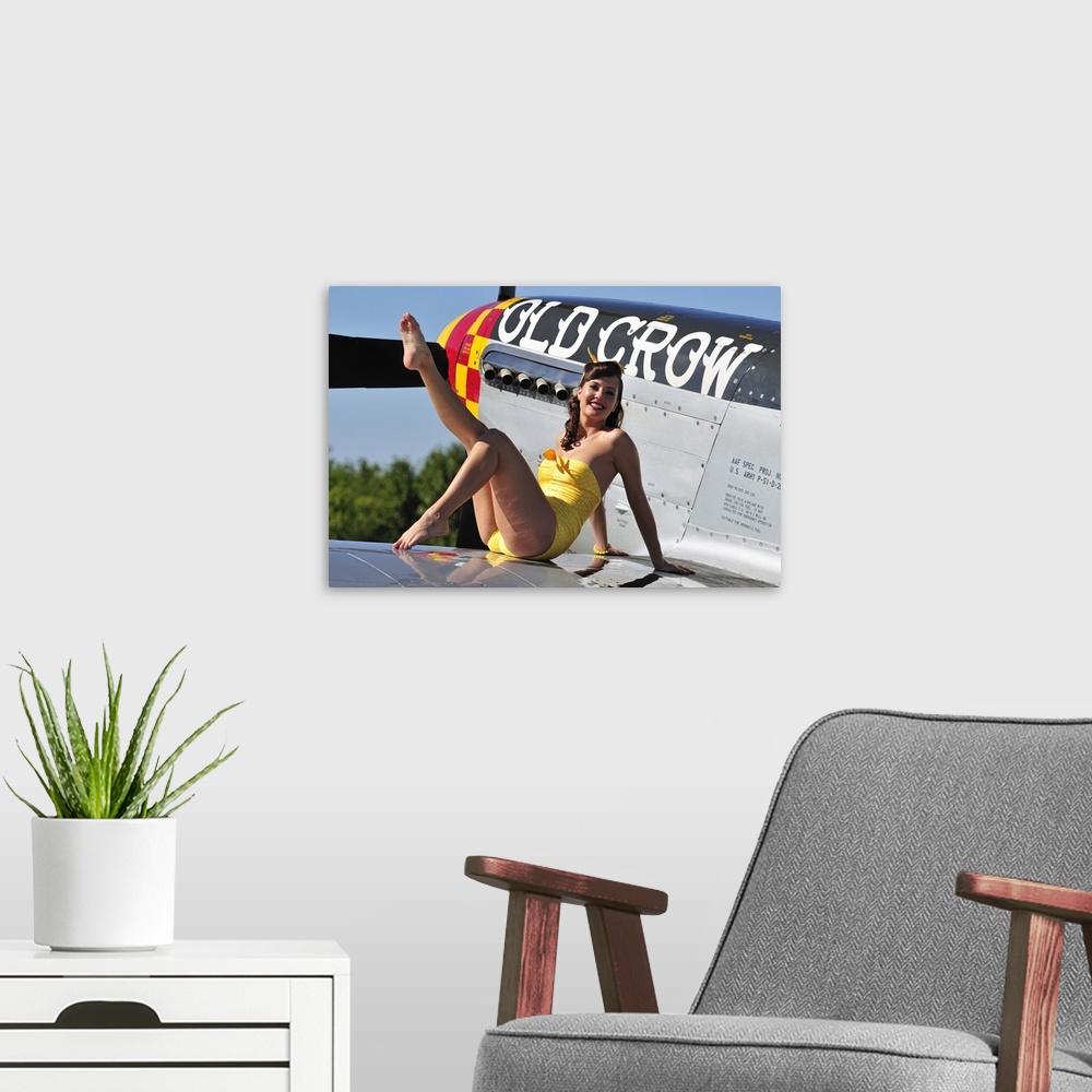 A modern room featuring Cute pin-up girl sitting on the wing of a World War II era P-51 Mustang fighter plane.
