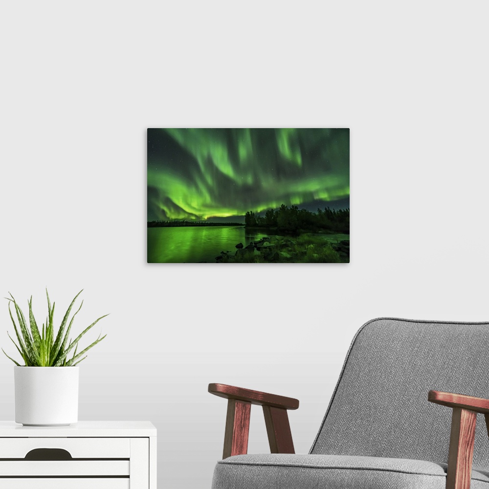 A modern room featuring A bright sky-filling aurora at Tibbitt Lake east of Yellowknife, Canada.