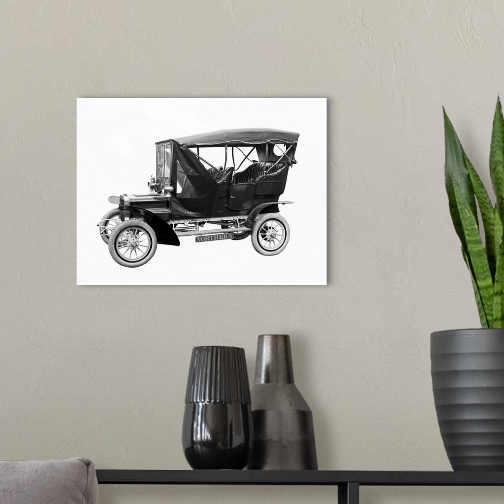 A modern room featuring A vintage car manufactured by Northern Manufacturing Company from Detroit, circa 1906.