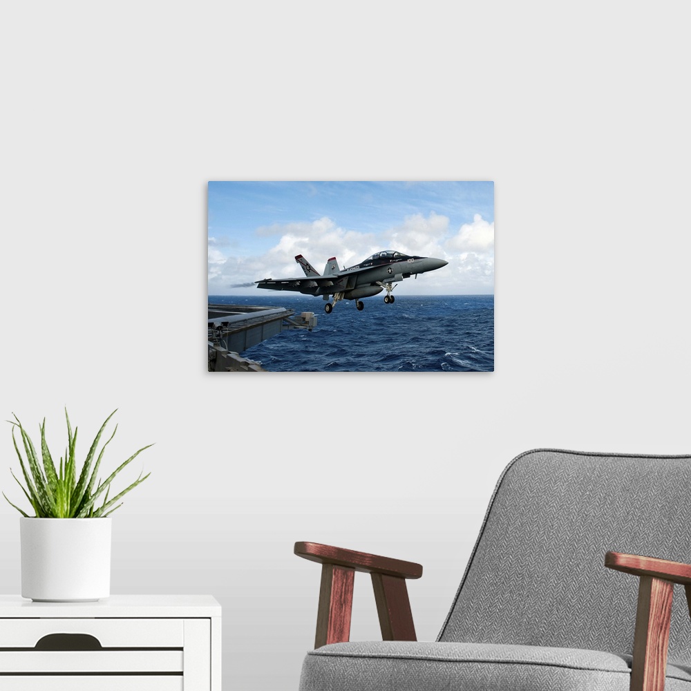 A modern room featuring An F/A-18F Super Hornet launches from USS John C. Stennis.