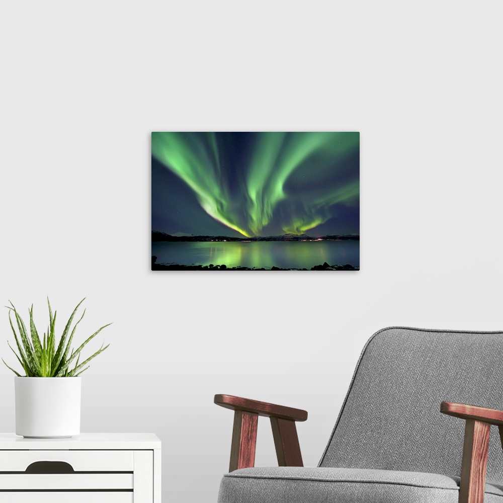 A modern room featuring Aurora Borealis over Tjeldsundet in Troms County, Norway. Auroras are the result of the emissions...
