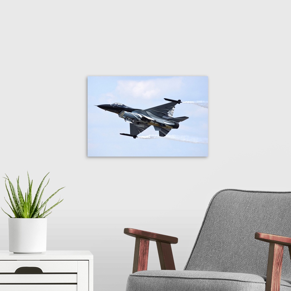 A modern room featuring Belgian Air Component F-16A taking off.