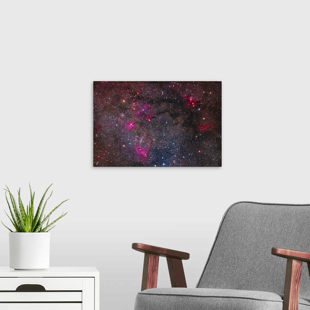 A modern room featuring A collection of bright star clusters and colorful nebulae on the border of Cassiopeia and Cepheus...