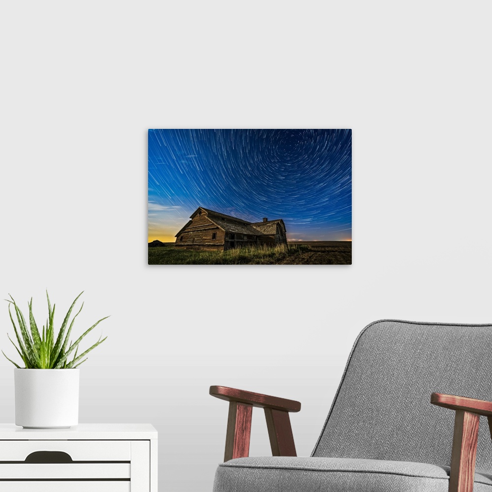A modern room featuring Circumpolar star trails over an old barn in southern Alberta, Canada.
