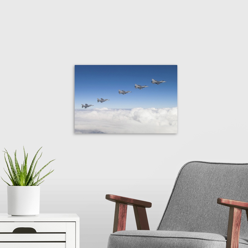 A modern room featuring Five F-16Cs of the U.S. Air Force 310th Fighter Squadron fly in formation.