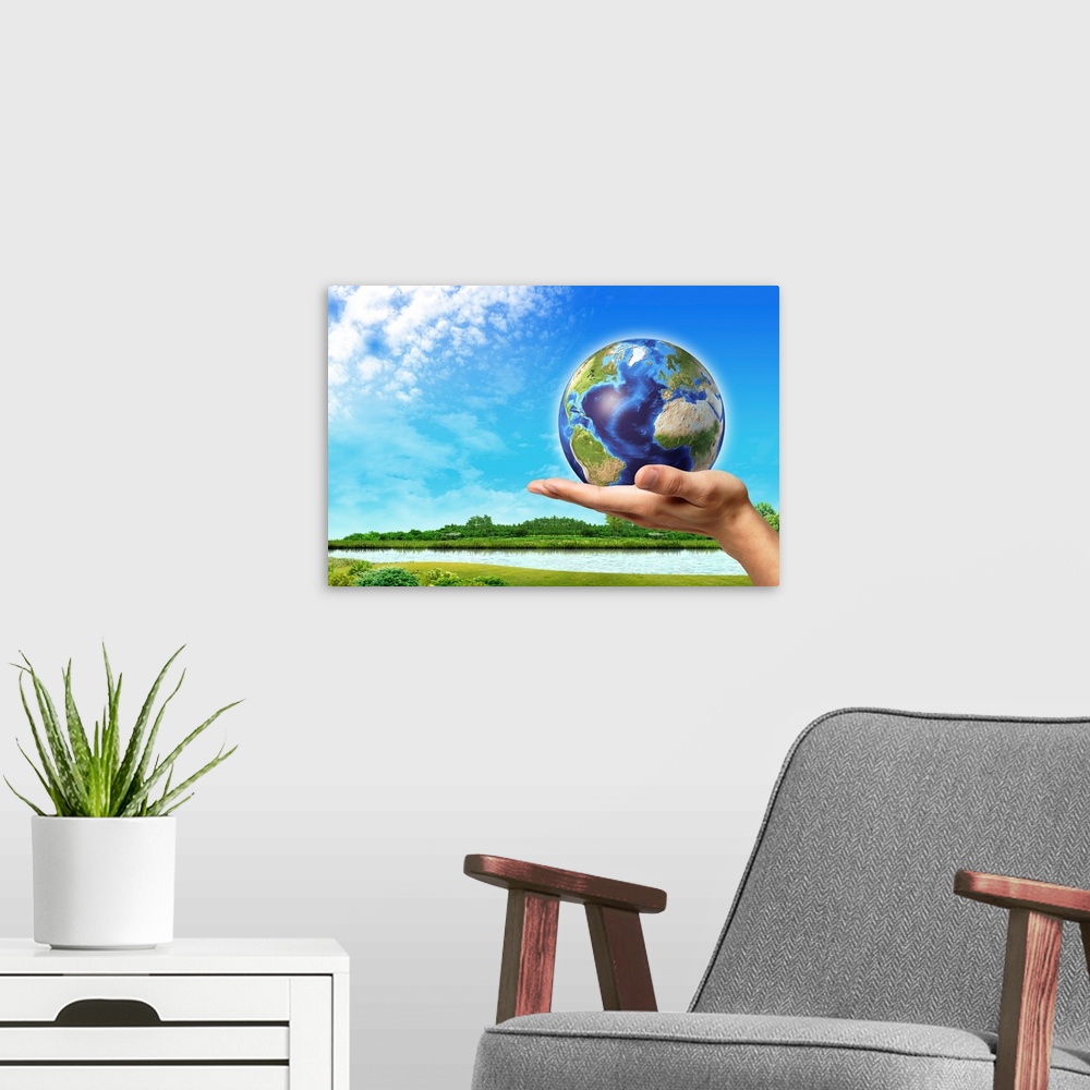 A modern room featuring Human hand holding Earth globe with a green landscape background.