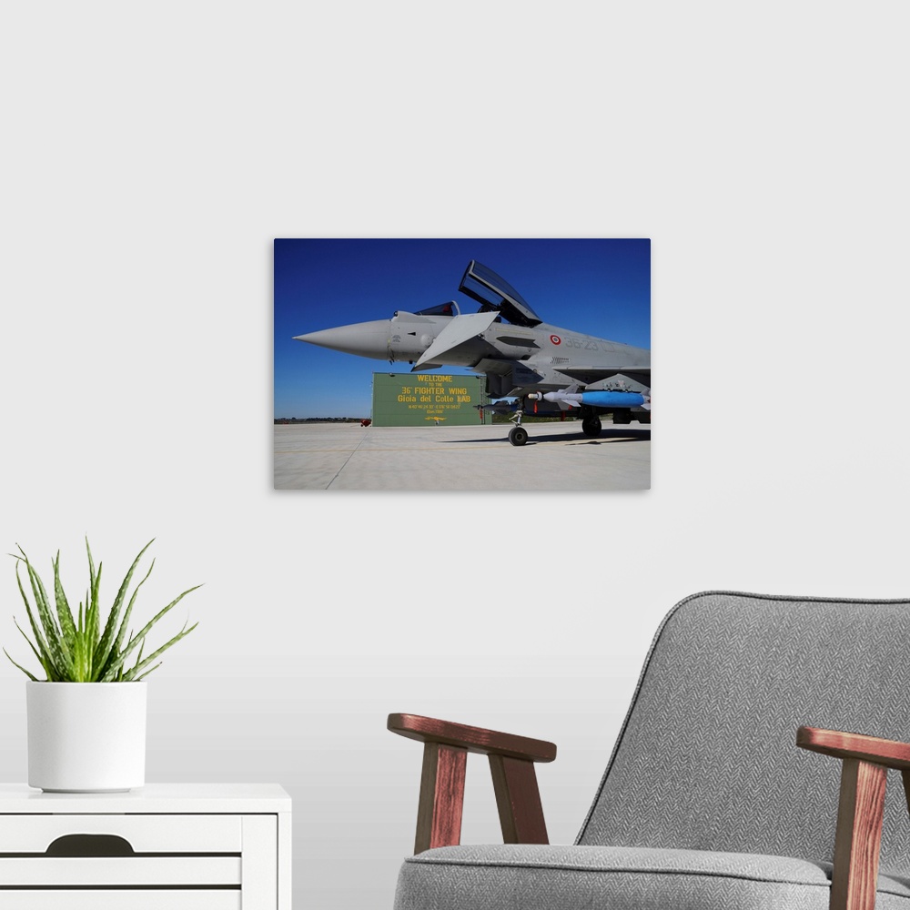 A modern room featuring Italian Air Force Eurofighter F-2000 armed with bombs.