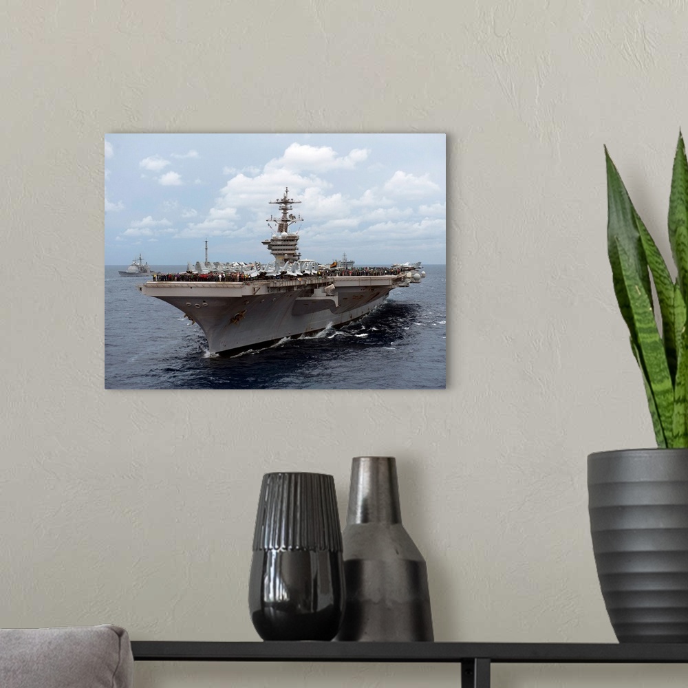 A modern room featuring Nimitz class aircraft carrier USS Carl Vinson transits the Bay of Bengal.