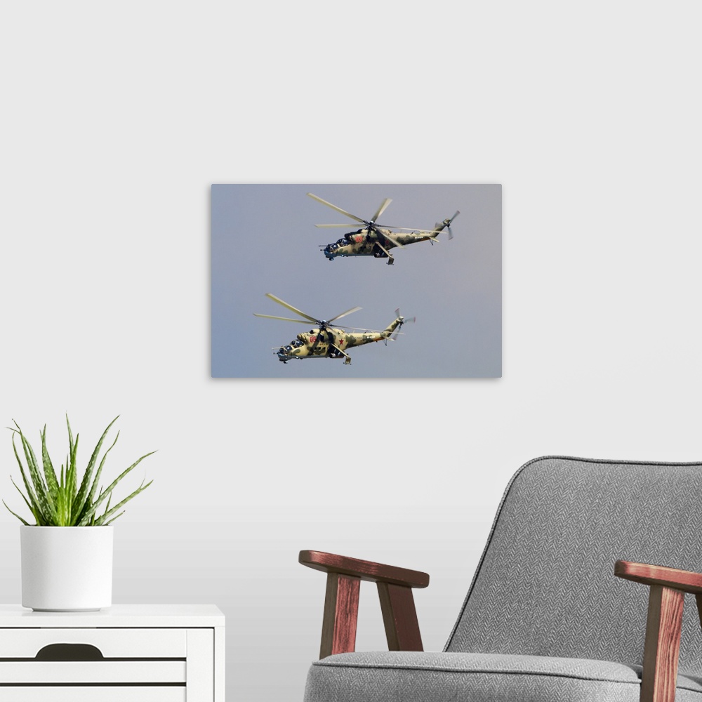 A modern room featuring Pair of Mil Mi-24P attack helicopters of Russian Air Force.