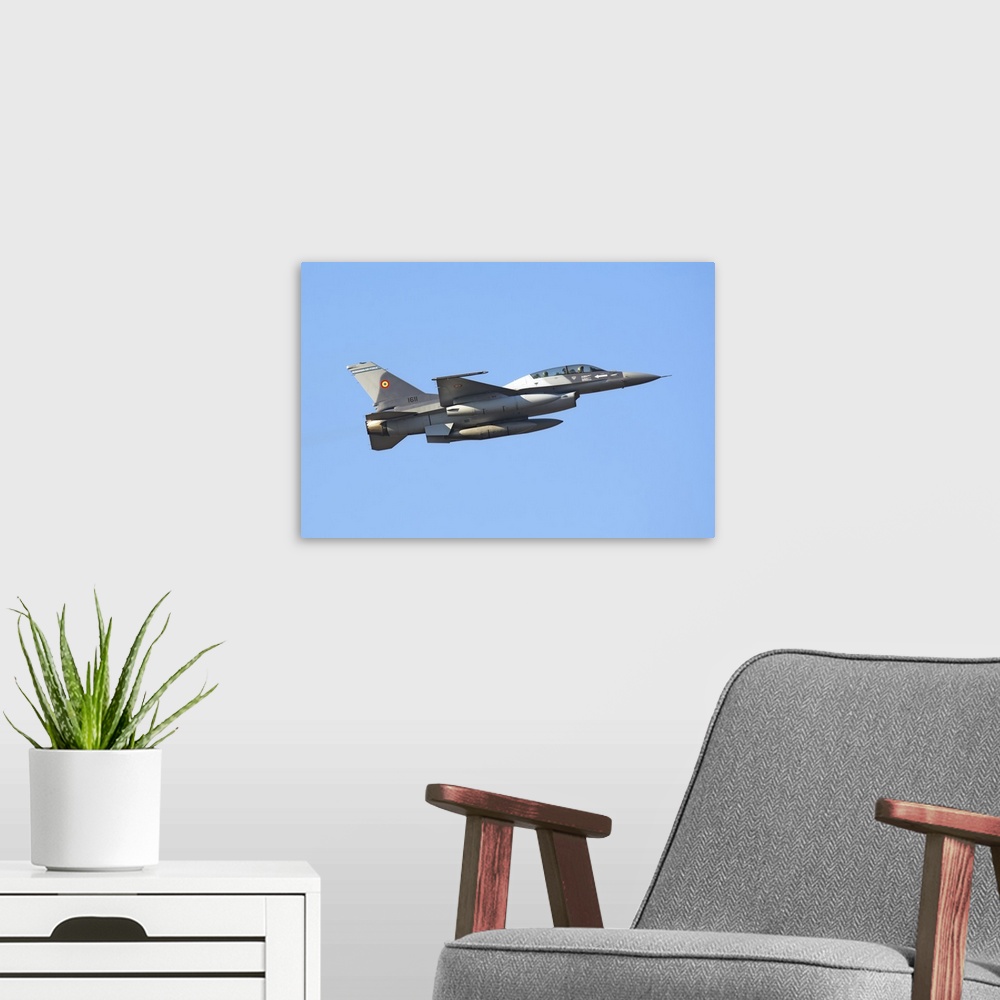 A modern room featuring Romanian Air Force F-16B Block 20 MLU takes off from Aviano Air Base, Italy, after a fuel stop du...