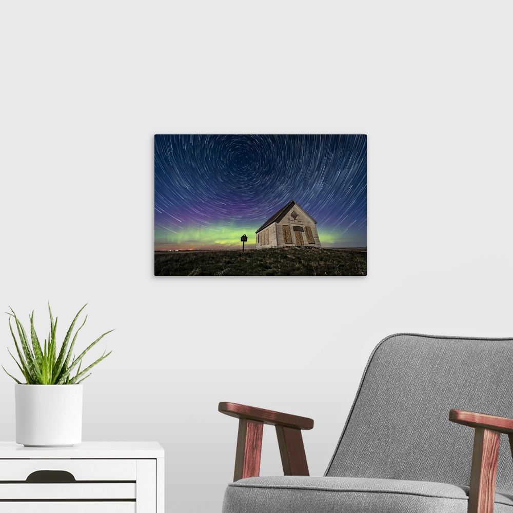 A modern room featuring Star trails above the 1910 Liberty Schoolhouse in Alberta, Canada.