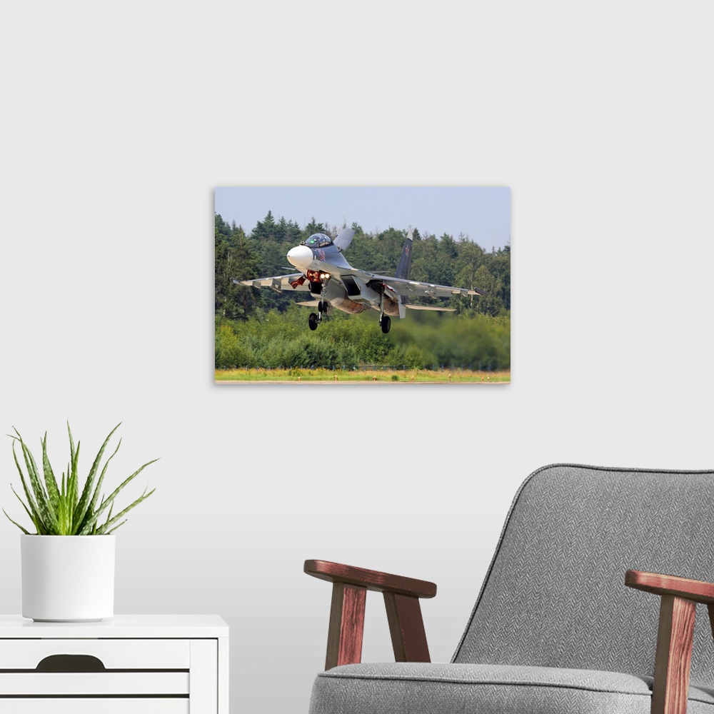 A modern room featuring Su-30SM jet fighter of Russian Air Force landing, Kubinka, Russia.