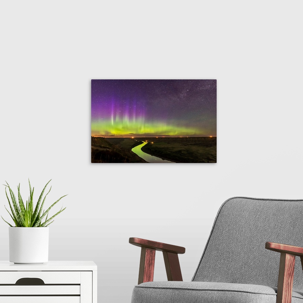 A modern room featuring The northern lights dance over the Red Deer River and Badlands of Alberta, Canada.