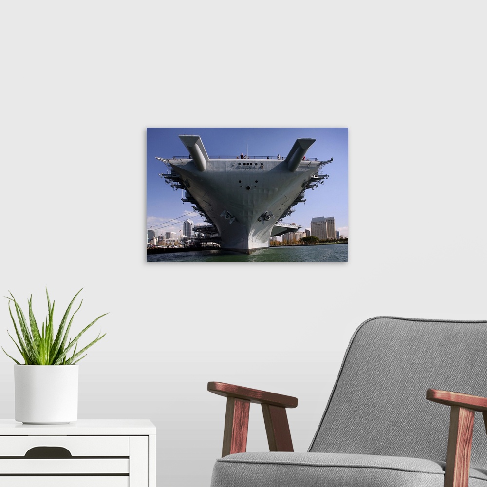 A modern room featuring The USS Midway berthed pierside