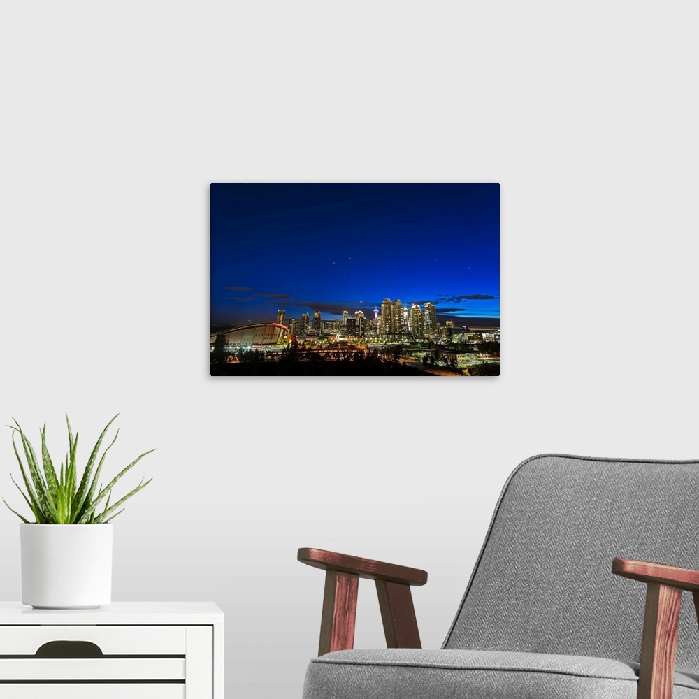 A modern room featuring Venus and stars setting over the skyline of Calgary, Canada.